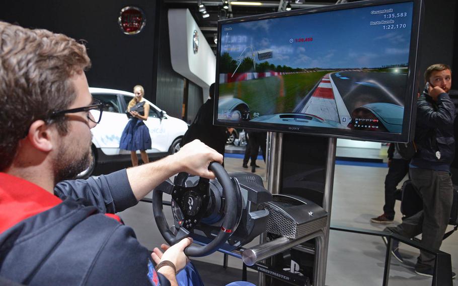 Visitors to the International Motor Show in Frankfurt, Germany, can try their hand at virtually racing a car around a track at many of the carmakers' exhibit stands.