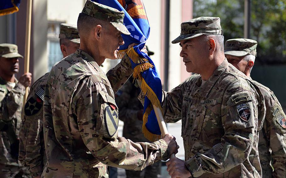 At a ceremony in Kabul, Afghanistan, Gen. John F. Campbell, commander, Resolute Support, right, passes the unit colors to Maj. Gen. Gordon "Skip" Davis, incoming commander for Combined Security Transition Command - Afghanistan. Maj. Gen. Todd T. Semonite relinquished command during the change of command ceremony Thursday, Oct. 1, 2015, in Kabul.