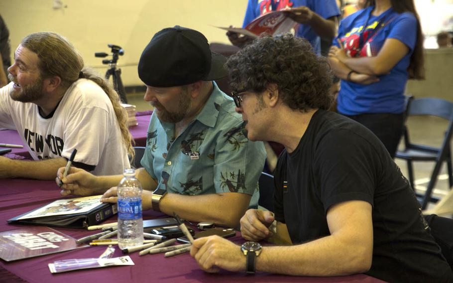 'Dragon Ball Z' voice actors Justin Cook, left to right, Christopher Sabat and Sean Schemmel sign autographs for fans Saturday, Oct. 17, 2015, during Comic Con Okinawa at Camp Foster, Japan. More than 10,600 people attended the annual convention, which celebrates popular culture and comics.