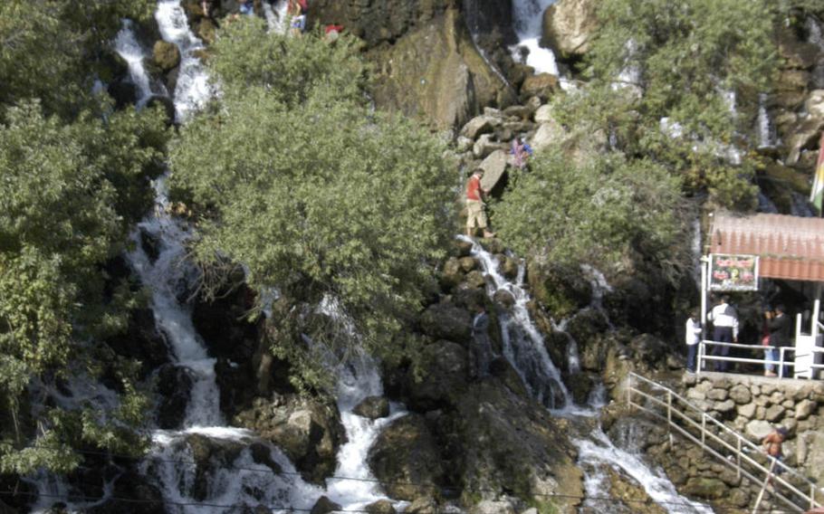 Tourists climb a waterfall in Iraqi Kurdistan in late October 2015.