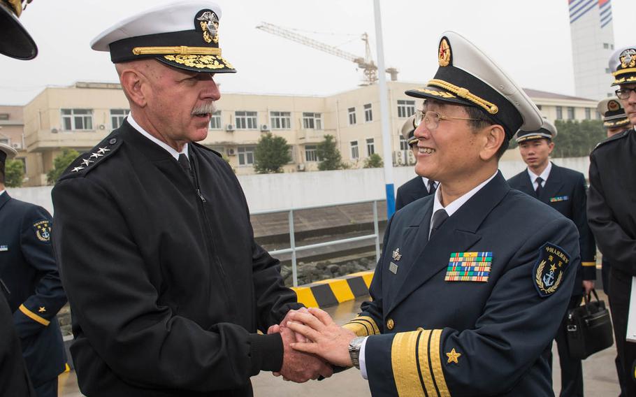 U.S. Pacific Fleet Commander Adm. Scott H. Swift greets Vice Adm. Su Zhiqian, the East Sea Fleet commander of the Chinese People's Liberation Army Navy, after touring the Jiangkai II class guided-missile frigate Xuzhou on Tuesday, Nov. 17, 2015, in conjunction with a port visit of the forward-deployed Arleigh Burke-class guided-missile destroyer USS Stethem in Shanghai.