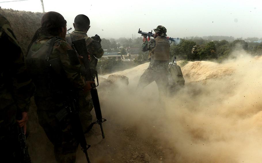 An Afghan soldier fires a rocket-propelled grenade at Taliban positions on the outskirts of Kunduz during mop-up operations in October 2015. It took nearly two weeks of house-to-house fighting before most pockets of Taliban resistance had been eliminated.