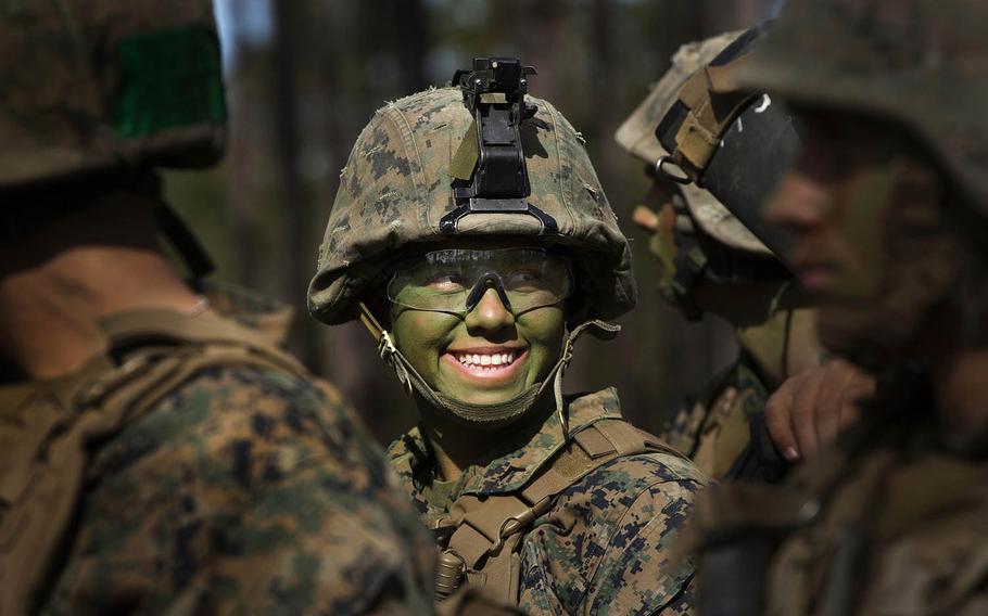 Pfc. Christina Fuentes Montenegro, of Coral Springs, Fla., and other Marines from Delta Company, Infantry Training Battalion, School of Infantry-East, receive final instructions prior to assaulting an objective during the Infantry Integrated Field Training Exercise aboard Camp Geiger, N.C., Nov. 15, 2013. Montenegro was of the first three female Marines to graduate infantry training with the battalion as part of integration study conducted by the service.