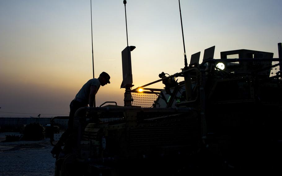 Spc. Samuel L. Esposito, with the 317th Brigade Engineer Battalion, 3rd Brigade Combat Team, 10th Mountain Division (Light Infantry), closes the hood on a Mine Resistant Ambush Protected vehicle at Bagram Air Field, Afghanistan, Jan. 12, 2016.