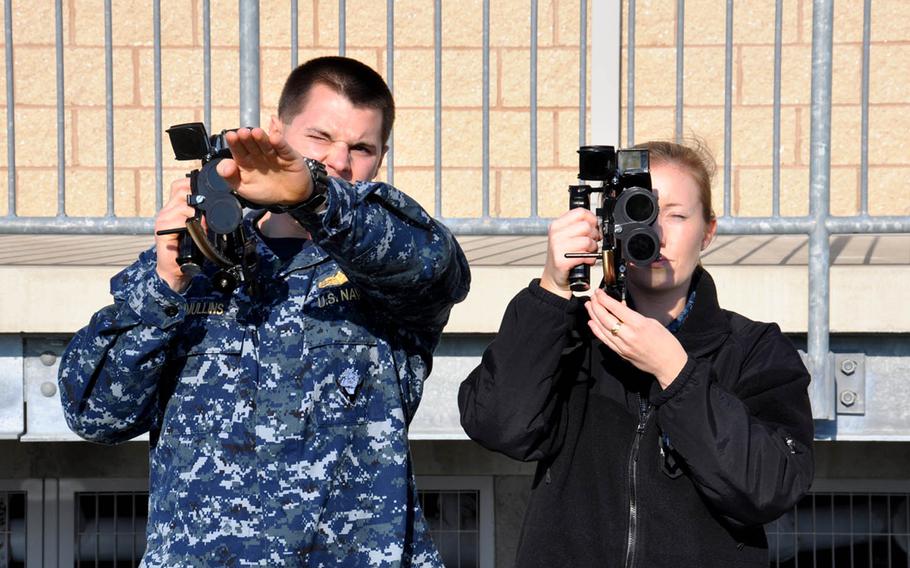 Lt. Kevin Mullins, Surface Warfare Officer School surface navigator course leader, instructs Lt. Corey Schulz on proper sextant procedures, Dec. 10, 2015, in Newport, R.I. The sextant is used to take the altitude of the sun at Local Apparent Noon to determine latitude in celestial navigation.