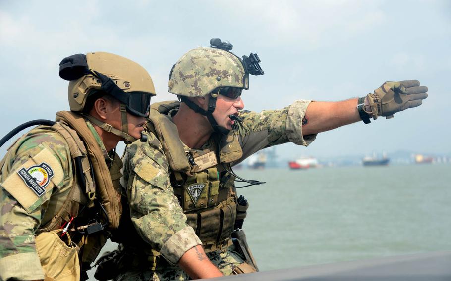 Boatswain's Mate 1st Class Kevin Diebold, right, assigned to Coastal Riverine Squadron 3, communicates with an Indonesian Kopaska Naval Special Forces team leader while practicing interdiction techniques during Cooperation Afloat Readiness and Training Indonesia, Aug. 7, 2015. Depth, including the addition of drones and other high-tech weapons, more gunnery and training to intercept smugglers, will be added to this year's CARAT exercises.