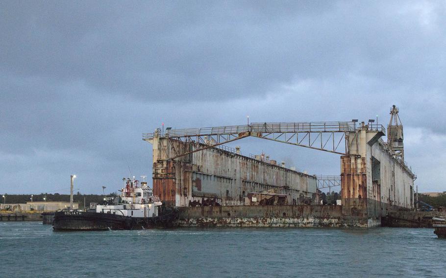 The drydock Richland was towed out of Apra Harbor, Guam, Jan. 28, 2016, with the help of several local tug boats and the large Philippine tug Rhocas. The open-sea tow to the Philippines will take several days.