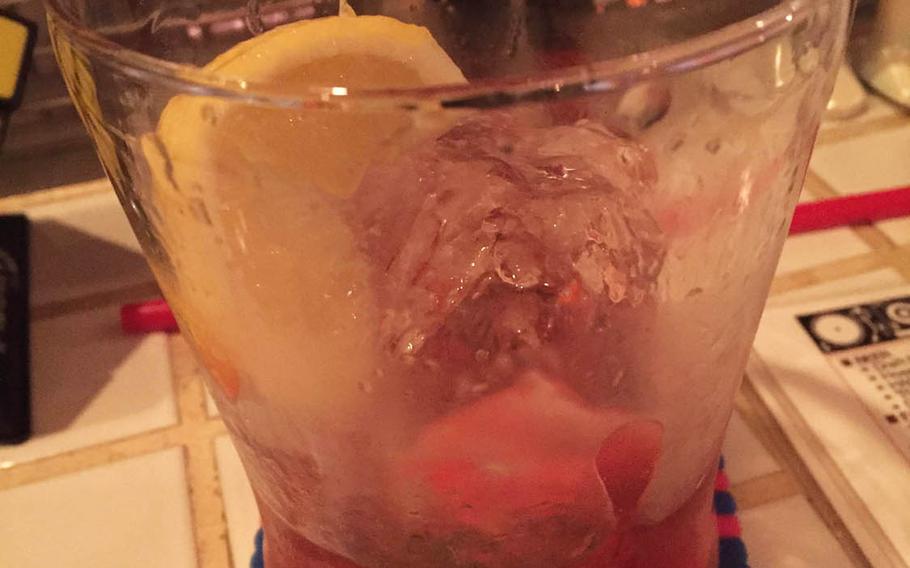 The Flower of Evil cocktail at 8 Bit Cafe, named for the Little Shop of Horrors-like plant that pops out of pipes in "Super Mario Bros.," features Campari and bourbon served on the rocks in a large glass with a slice of lemon.
