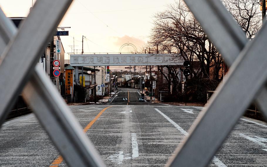 The remains of a sign reading ''Nuclear power: Energy for a bright future'' stands over the barricaded road along National Route 6 in the ghost town Futaba, Japan, less than 10 miles from the severely damaged Fukushima Dai-ichi nuclear power plant. The characters on the sign were removed in December due to deterioration.