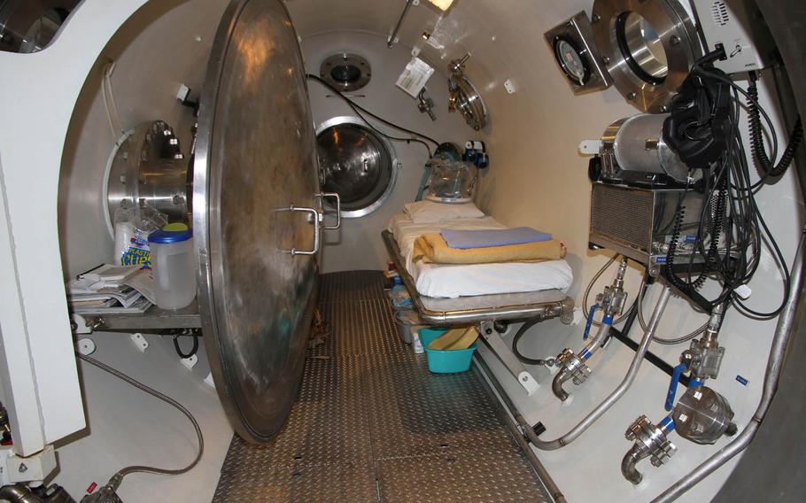 A hatch leads to the interior of the decompression chamber that treats the bends at Naval Base Guam. It has one patient bed and space for one medical technician to oversee care during the approximately seven-hour sessions.