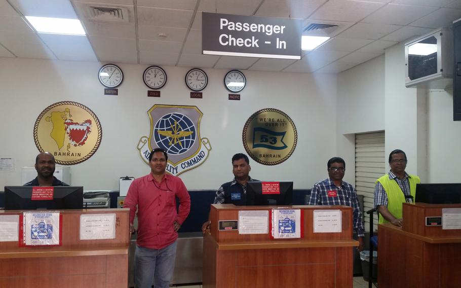 Staff members Gerson Fernandes, Prem Kandoth, Nepolian Punniamoorthy, Bobby Henry and Nicalas Fernandez, stand at the passenger check-in counter at the Bahrain Passenger Terminal. Commander, Task Force 53 and other Naval entities are currently making improvements to make passengers' experience at the terminal more comfortable.