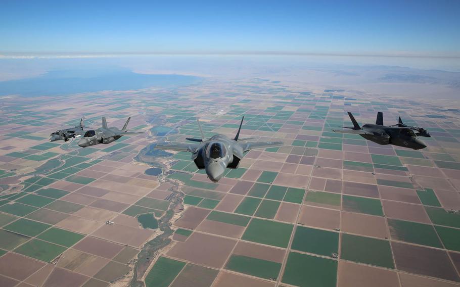 Three F-35B Lightning II Joint Strike Fighters with Marine Fighter Attack Squadron 121, 3rd Marine Aircraft Wing, and two AV-8B Harriers with Marine Attack Squadron 211, 3rd MAW, fly in formation over eastern California in 2013. Assistant Secretary of the Navy Sean Stackley announced plans to deploy F-35 stealth fighters to Marine Corps Air Station Iwakuni next January at a congressional hearing on Wednesday, March 23, 2016.