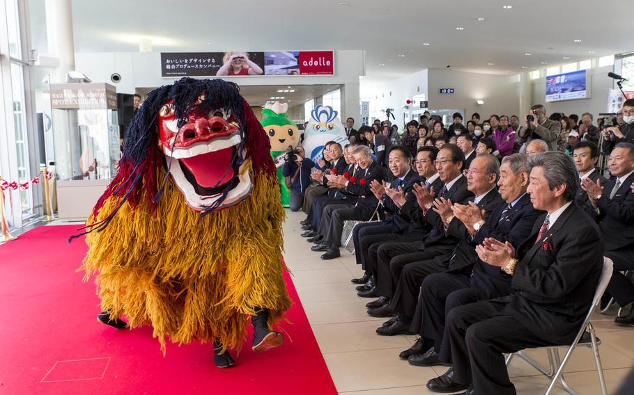 Officials and guests celebrate the addition of two flights out of Marine Corps Air Station Iwakuni, Japan, Sunday, March 27, 2016. The event included an Eisaa Okinawa drum demonstration, a Ryuky-Koku-Matsuri daiko drum performance and a ribbon-cutting ceremony.