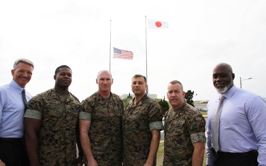 Marines who helped subdue an unruly passenger on a flight last week from Honolulu to Tokyo pose at Camp Foster, Okinawa, Thursday, March 31, 2016. Pictured, from left, are: Daniel Deamon, deputy inspector general; Staff Sgt. Timothy Bell, 1st Marine Air Wing equal opportunity adviser; Gunnery Sgt. Paul Corner, Marine Corps Installations Pacific inspector general chief; Col. Lou Cala, 1st Marine Air Wing inspector general; Maj. Troy Cronbaugh, Marine Corps Installations Pacific operations officer; and Devery Grady, of Marine Corps Installations Pacific G-8 planning.