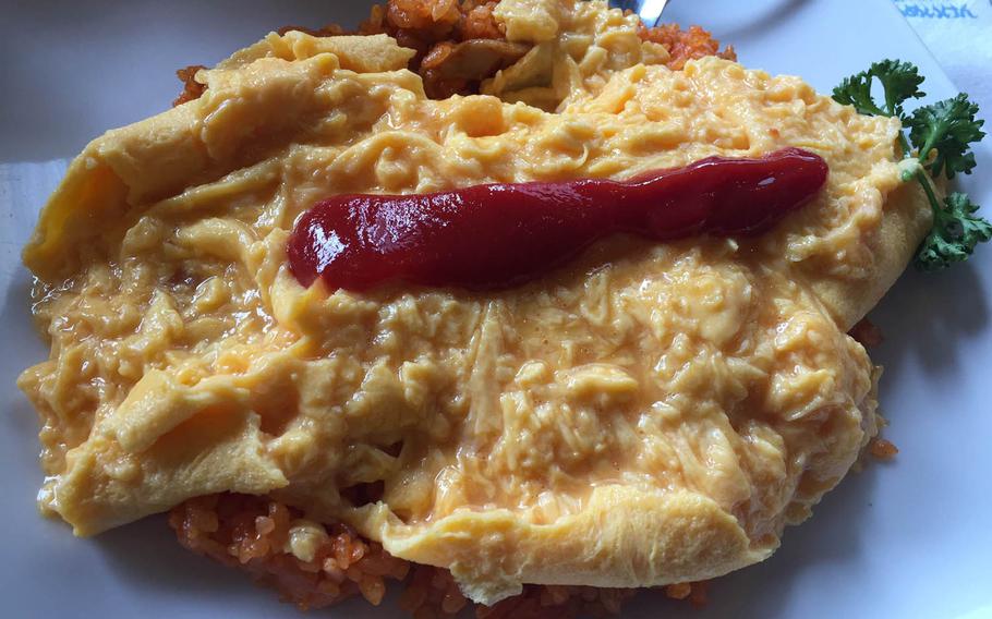 Tampopo omurice, the signature dish at Taimeiken in Nihonbashi, Tokyo, is named after the 1985 food-centered Japanese film "Tampopo." Diners are instructed to cut the omelet down its center, revealing its soft-cooked interior.