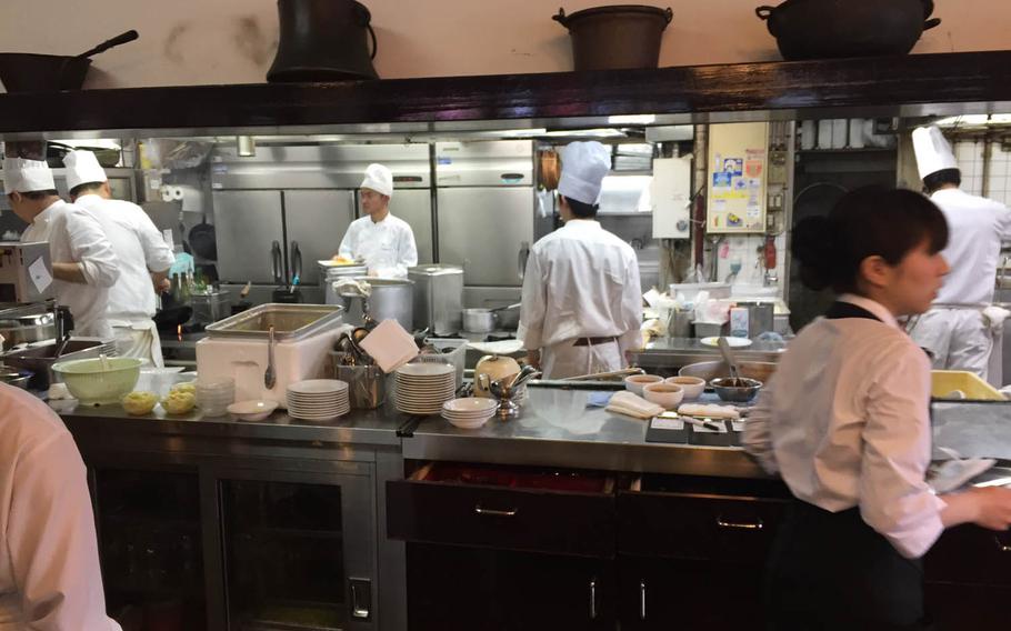 The staff at Taimeiken work through a busy lunch shift April 1 in Nihonbashi, Tokyo. The popular restaurant is known for its Tampopo omurice, a soft-cooked three-egg omelet served over ketchup-fried rice.