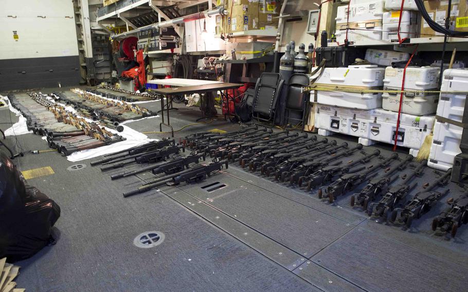 A cache of weapons is assembled on the deck of the guided-missile destroyer USS Gravely on March 31, 2016. The weapons were seized three days earlier from a stateless dhow, which was intercepted by the coastal patrol ship USS Sirocco. The cargo included 1,500 AK-47s, 200 rocket-propelled grenade launchers and 21 .50-caliber machine guns.