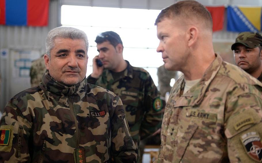 Afghan army chief of staff Gen. Qadam Shah Shaheem, left, speaks with U.S. Army Maj. Gen. Jeffrey Buchanan, deputy chief of staff for operations for the Resolute Support mission, at an airport in Mazar-i-Sharif after meeting with regional security forces in Kunduz, Afghanistan, on Monday, April 03, 2016.
