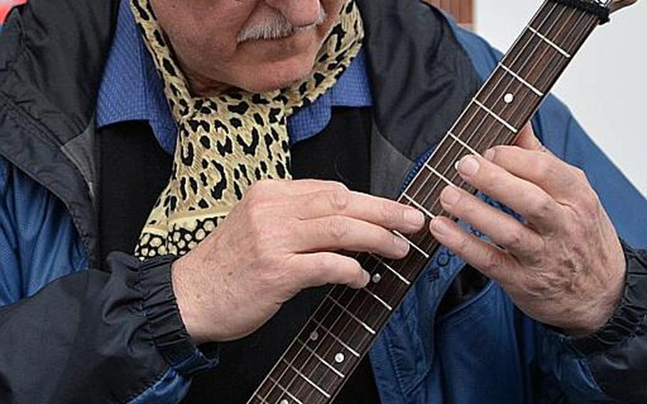 A guitarist strums a Milenko Katanic electric guitar at the Musikmesse in Frankfurt, Germany, Thursday, April 7, 2016. The company's guitars are compact with small bodies.