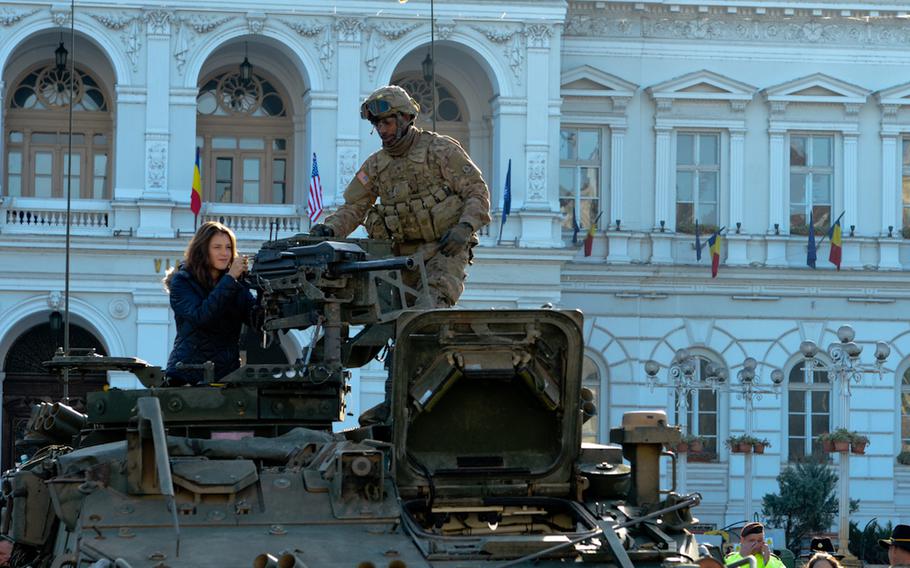 A cavalry sergeant from the 4th Squadron, 2nd Cavalry Regiment, informs a Romanian woman about a Stryker military vehicle in Arad, Romania, Oct. 25, 2015, as part of Exercise Dragoon River Crossing. The exercise took place across Estonia, Latvia, Lithuania, Poland and Romania to strengthen relationships among allied militaries. The U.S. will be beefing up its presence in eastern Europe in 2017 with the addition of a rotational brigade.