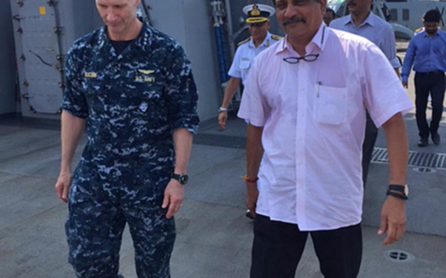 Indian Defense Minister Manohar Parrikar arrives on the deck of the USS Blue Ridge, flagship of the U.S. 7th Fleet currently on a port visit to Goa, India, on Monday, April 11, 2016. At left is Vice Adm. Joseph Aucoin, 7th Fleet commander. Parrikar visited the ship with Defense Secretary Ash Carter.