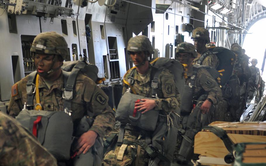 Soldiers from the 173rd Airborne Brigade, loaded down with gear, board a C-17 at Aviano Air Base, Italy, on Monday, April 11, 2016, as part of exercise Saber Junction.