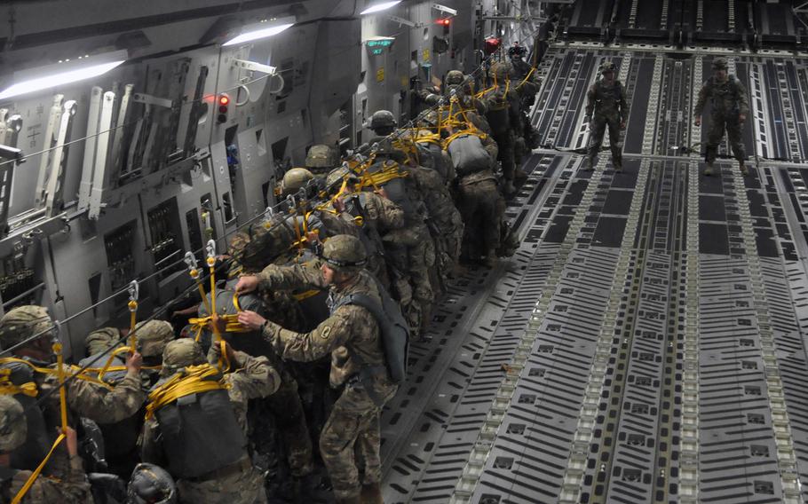 Soldiers from the 173rd Airborne Brigade and Italian troops get set to jump out of a C-17 above Hohenfels, Germany, on Monday, April 11, 2016, as part of exercise Saber Junction. Fifty-one made it out of the plane, but six had to return to Aviano Air Base after winds were judged to be too strong during the aircraft's third pass over the zone.