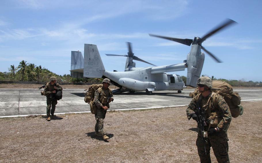 Marines disembark from an MV-22 Osprey after landing at an airstrip in Panay, Philippines, during Exercise Balikatan, Monday, April 11, 2016. The Marines were acting as a follow-up force for an earlier amphibious landing by Filipino marines. 