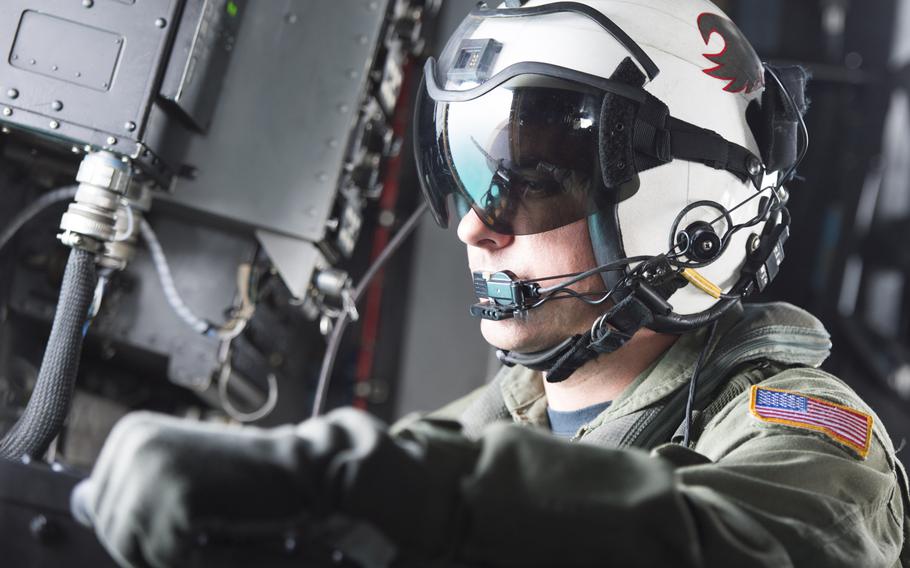 An aircrew member of an MH-53E Sea Dragon mans a weapon during transit over the Persian Gulf for the International Mine Countermeasures Exercise April 10, 2016.