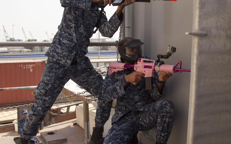 Sailors from a Bahraini Royal Navy special task force prepare to enter a room during a visit, board, search and seizure demonstration for the International Mine Countermeasures Exercise at Naval Support Activity Bahrain April 9, 2016.