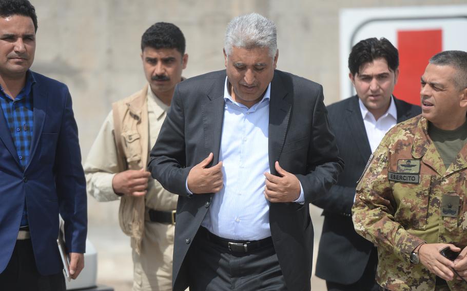 The provisional governor of Herat province, Mohammad Asif Rahimi, arrives at the first official meeting of the Afghanistan Airfield Economic Development Commission's Herat chapter at Camp Arena, April 7, 2016.He called for greater clarity on the international coalition's future presence at the base, which includes the Herat Airfield.