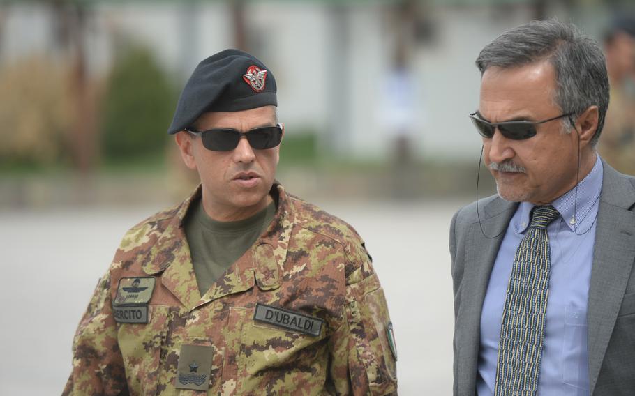 Italian Commander Brig. Gen. Mauro D'ubaldi speaks with Daoud Sultanzoy, chairman of the Afghanistan Airfield Economic Development Commission, on the sidelines of a meeting of the Afghanistan Airfield Economic Development Commission's Herat chapter, Camp Arena, April 7, 2016. D'ubaldi said he would try to ensure the continued presence of international troops would not hinder the airfield's transformation into an economic zone.