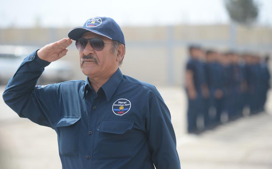 Haha Maqsoodi, head of the fire fighter brigade at Afghanistan's Herat Airport's international terminal salutes those attending the first official meeting of the Afghanistan Airfield Economic Development Commission's Herat chapter, April 7, 2016.