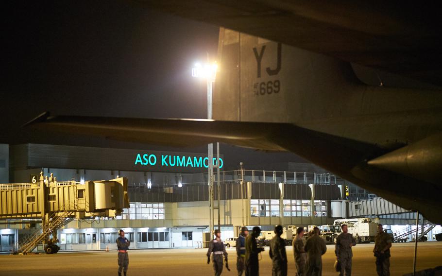 Airmen from Yokota Air Base's 374th Airlift Wing and Japan Ground Self-Defence Force personnel offload a C-130 Hercules at Kumamoto Airport on Monday, April 18, 2016. The airlifters have delivered six JGSDF utility vehicles and several Japan self-defence force personnel since beginning the humanitarian assistance mission Monday.