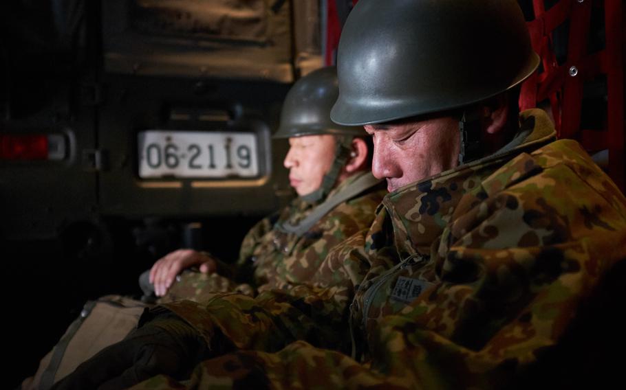 Soldiers from the Japan Ground Self-Defense Force take a nap inside a U.S. Air Force C-130 Hercules from Yokota Air Base en route to Kumamoto, Japan  Monday, April 18, 2016.