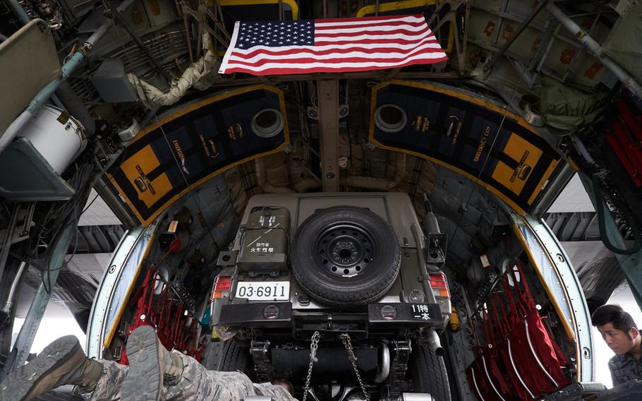 A Japan Ground Self-Defense Force military utility vehicle is tied down to a U.S. Air Force C130 Hercules from Yokota Air Base, Japan Tuesday, April 19, 2016 in Chitose, Japan. Yokota's airmen have delivered six vehicles and several JGSDF personnel deploying to Kumamoto, Japan.