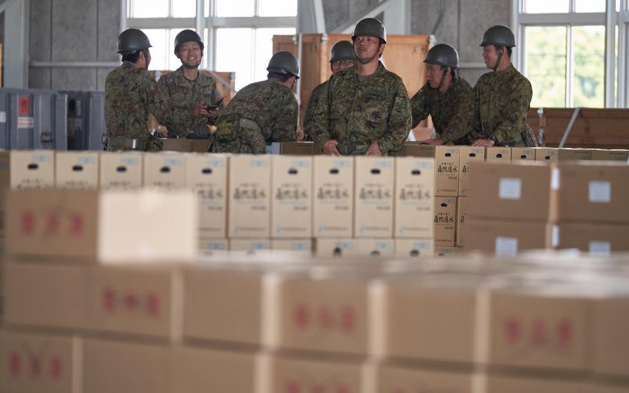 Soldiers from the Japan Ground Self-Defense Force wait for additional supplies to arrive to Camp Takayubaru in Kumamoto, Japan, on Wednesday, April 20, 2016.