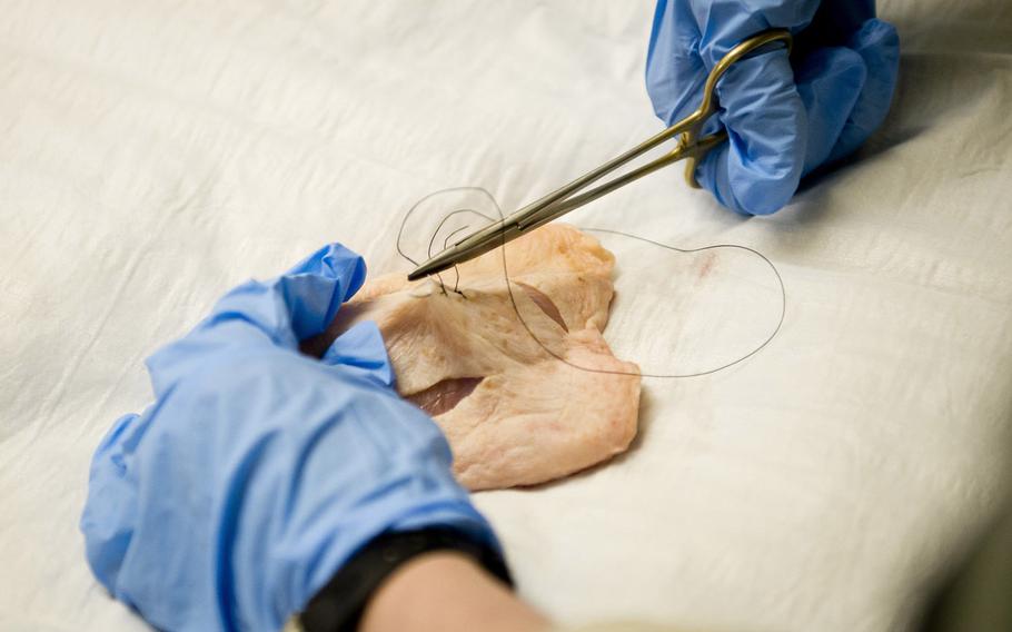 A 212th Combat Support Hospital nurse practices stitching a wound in Miesau, Germany, on Wednesday, April 20, 2016.