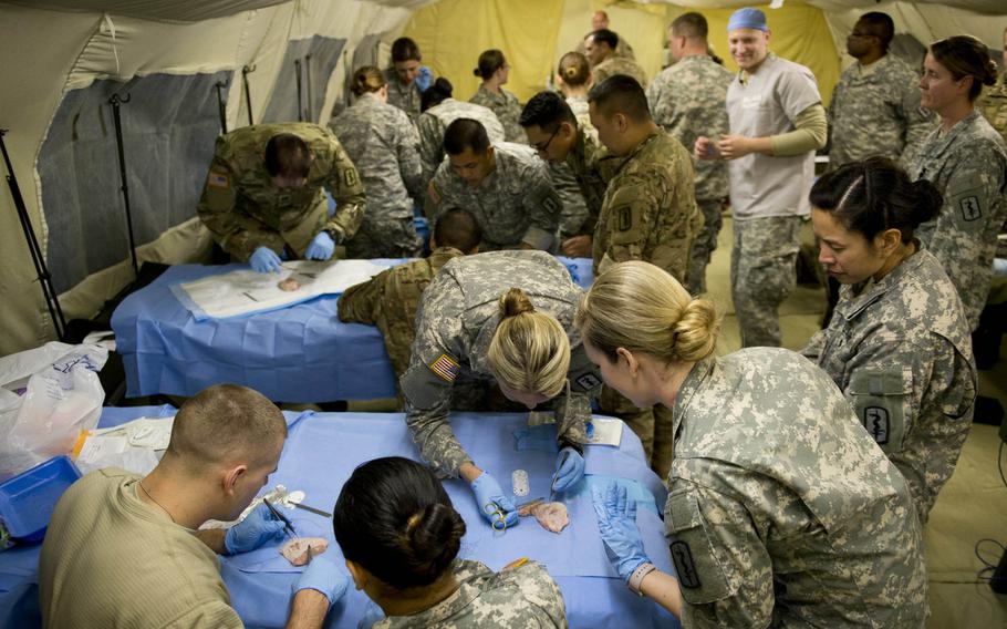 Medical personnel from the 212th Combat Support Hospital practice sutures in Miesau, Germany, on Wednesday, April 20, 2016.