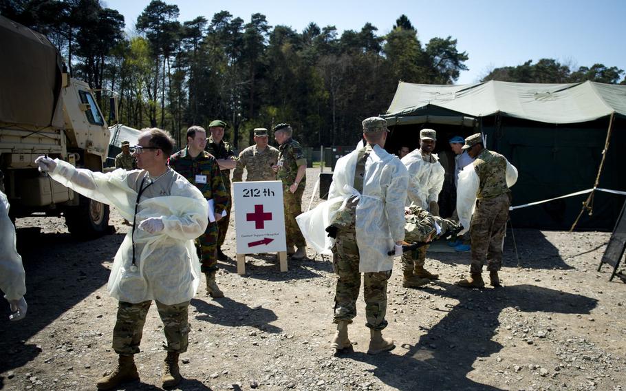 Medical personnel from the 212th Combat Support Hospital transport a simulated casualty during a mass casualty exercise in Miesau, Germany, on Wednesday, April 20, 2016. A NATO evaluation team was present to observe the exercise and give its recommendation on whether the expeditionary medical facility would be certified before upcoming Operation Anakonda.