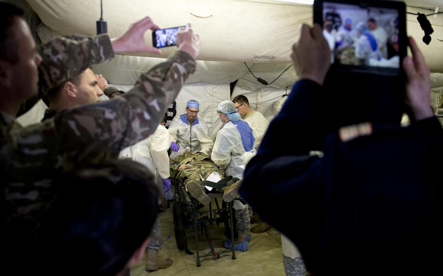 Medical personnel from the 212th Combat Support Hospital perform a mass casualty exercise for a NATO evaluation team in Miesau, Germany, on Wednesday, April 20, 2016.