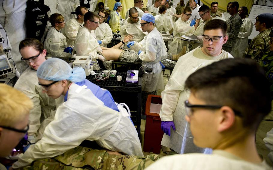 Personnel from the 212th Combat Support Hospital provide medical care to simulated patients during a mass casualty exercise in Miesau, Germany, on Wednesday, April 20, 2016. A NATO evaluation team was present to observe the exercise.