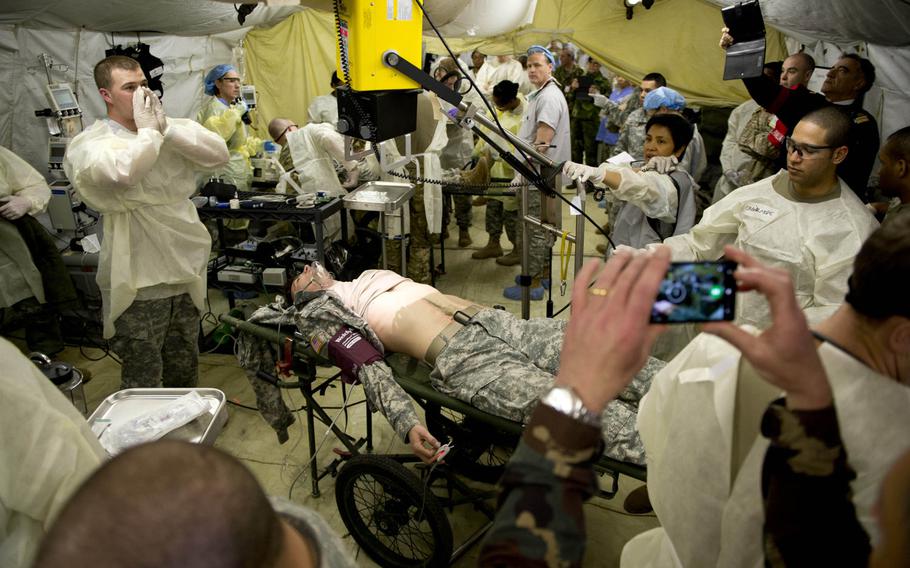 Medical personnel from the 212th Combat Support Hospital prepare a simulated patient for an X-ray during a mass casualty exercise in Miesau, Germany, on Wednesday, April 20, 2016.