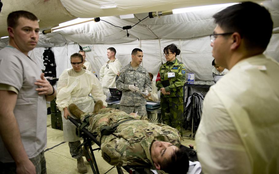 Medical personnel from the 212th Combat Support Hospital perform a mass casualty exercise for a NATO evaluation team in Miesau, Germany, on Wednesday, April 20, 2016.