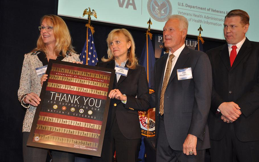 Olympic gold medalist Nancy Hogshead-Makar, left, Dr. Anne McKee, a neuropathologist and director of the VA brain bank, former Oakland Raiders linebacker Phil Villapiano and Chris Nowinski, president of the Concussion Legacy Foundation pose for a photo. Villappiano and Makar, a long with VA Secretary Bob McDonald, donated their brains to the brain bank for scientific research into brain injury and disease.