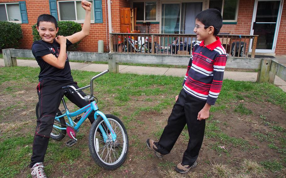 Children of Afghan immigrants who formerly worked as translators for the U.S. military show off for the camera at a Maryland apartment complex where many former interpreters have settled after arriving in the U.S.