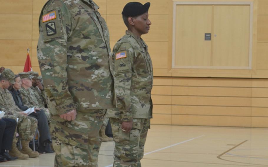 Col. Todd E. Fish, foreground, and Col. Mary E. Martin stand at attention during the U.S. Army Garrison Wiesbaden change of command ceremony Friday afternoon at Clay Kaserne. Fish, formerly of the South Korea-based 19th Expeditionary Sustainment Command, replaced Martin as commander.
