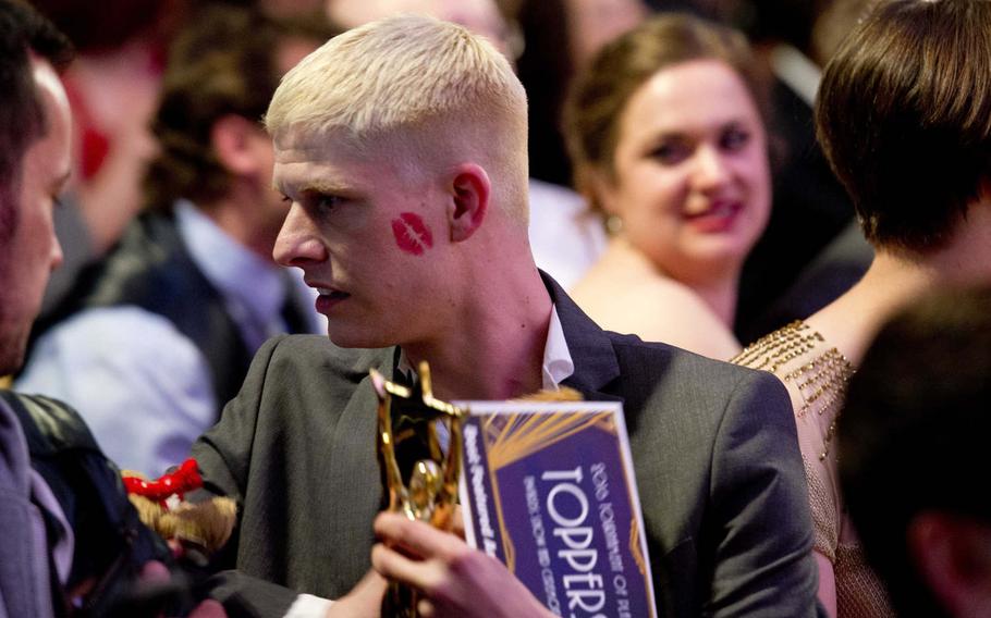 Philippe Michael Augustin holds his Topper after winning best actor in a featured role in a musical during the Toppers award show in Kaiserslautern, Germany, on Saturday, April 23, 2016. Augustin won for his portrayal of the old actor and Henry in the Amelia Earhart Playhouse production of "The Fantasticks."
                
