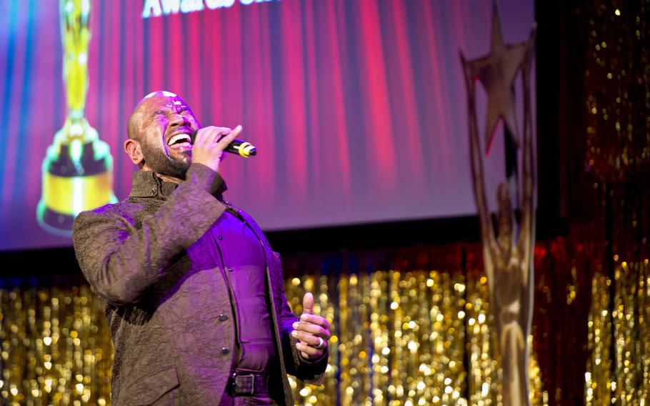 Guest performer David Moore, a performer and former U.S. soldier, sings "Wheels of a Dream" during the Toppers awards show in Kaiserslautern, Germany, on Saturday, April 23, 2016.
                