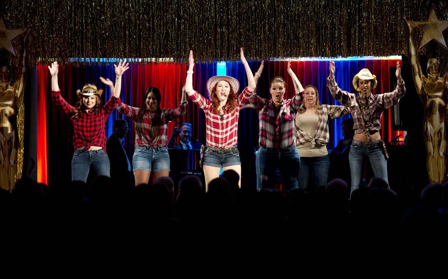 The Grafenwoehr Performing Arts Center cast of "Dirty Rotten Scoundrels" performs the song "Oklahoma?" during the Toppers awards in Kaiserslautern, Germany, on Saturday, April 23, 2016.
